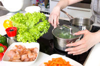Woman prepares a healthy meal in modern kitchen. C